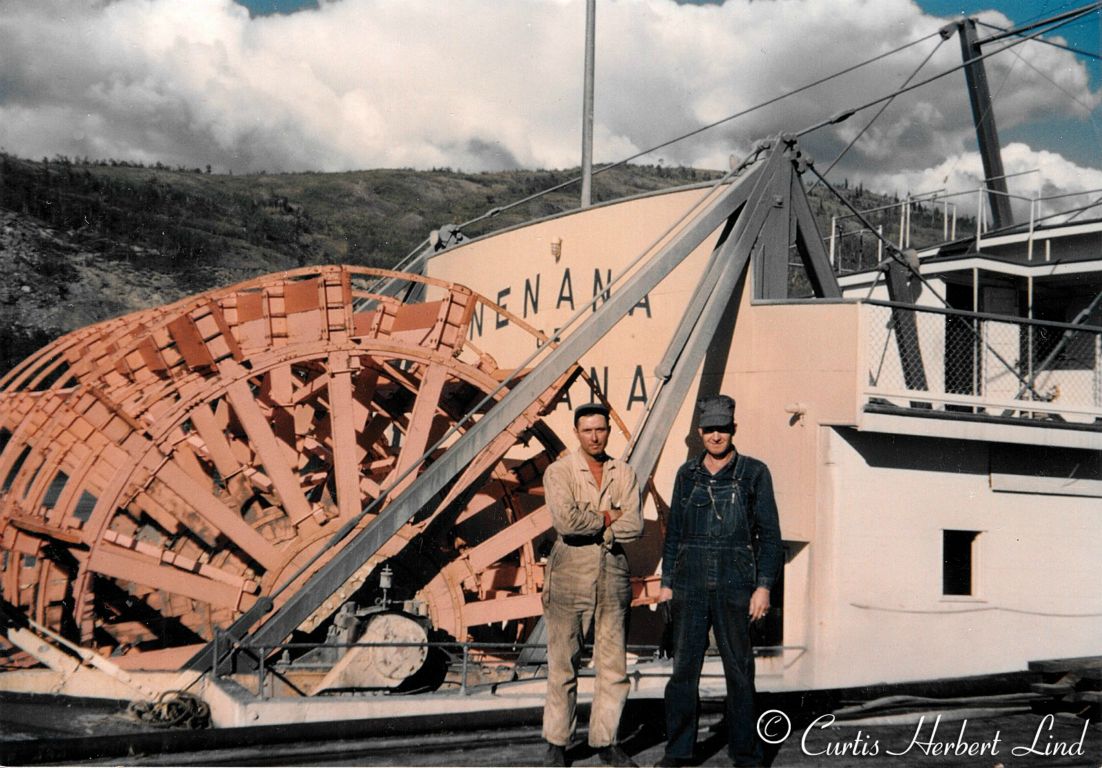 Paddle wheel of the Nenana River boat which was the largest on the interior rivers of Alaska and the Yukon. She is preserved today at Pioneer Park in Fairbanks.   Curt Lind at left.