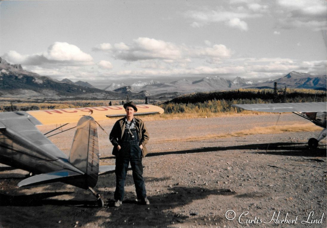Cessna 150? on one of of many gravel strips along the railroad in the Broad Pass area. Possibly Cantwell. Curt Lind in photo.