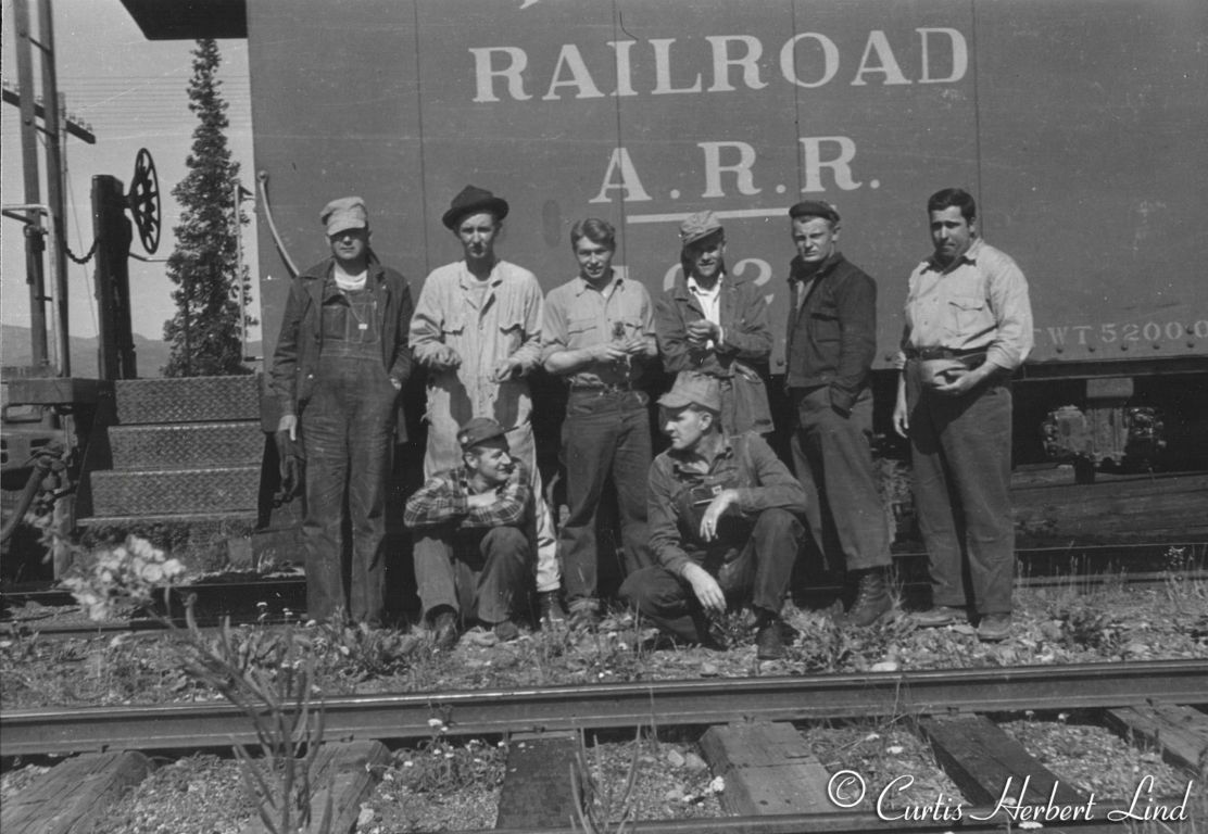 Caboose is one of five all steel cabooses #1022 to 1026 built new in 1946. Curt Lind standing second from left.