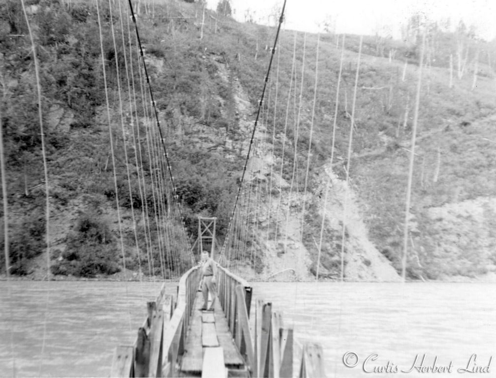 The suspension bridge was built across the Susitna River at Curry to allow access to the trail leading uphill to the right. That trail lead up the ridge to the Observation Hut in photo 50. The bridge is obviously in need of some repair. Today the only trace is some concrete foundations where the towers were on the Curry side. The cables were back stayed by being connected into several 55 gallon drums of concrete that were buried as anchors. 