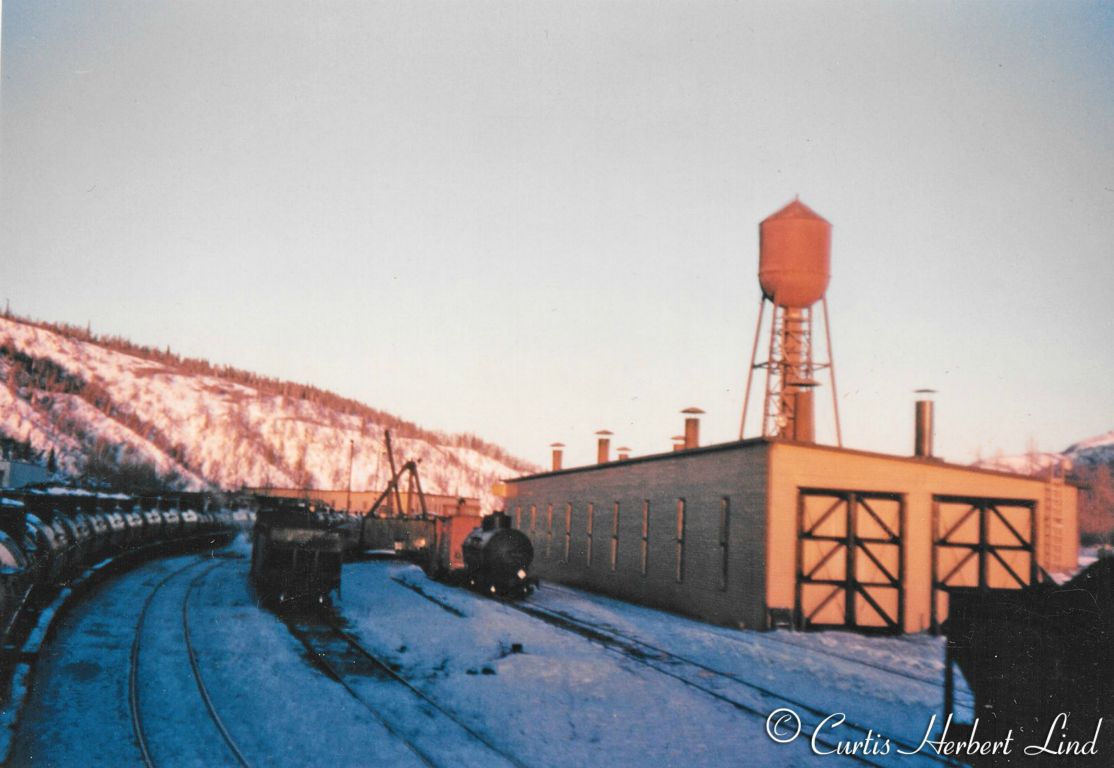 Engine facility at Healy Alaska with the two stall engine house, water tower and a stiff leg crane. The tank cars on the left are USATC 10,000 gallon tanks used to move fuel from Whittier to Fort Wainwright and Ladd Field later Eielson AFB out of Fairbanks. Date is after 1948 when the ARR structures were repainted from Park Service Green and White to tan with brown trim.Healy roundhouse. On May 10, 1952 the 250 by 50-foot roundhouse at Healy was destroyed by fire, along with 2 diesel locomotives, a large crane, a railroad ambulance and tools and other equipment. 